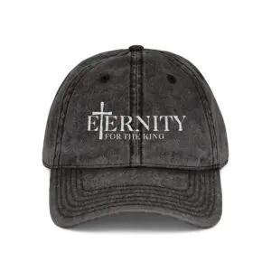 Worn black cap with 'Eternity' and a cross logo.