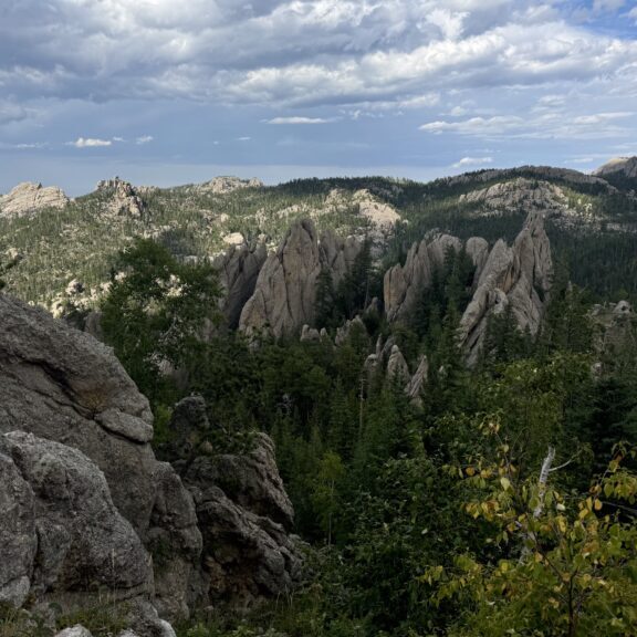 Scenic rocky mountain landscape under a partly cloudy sky.