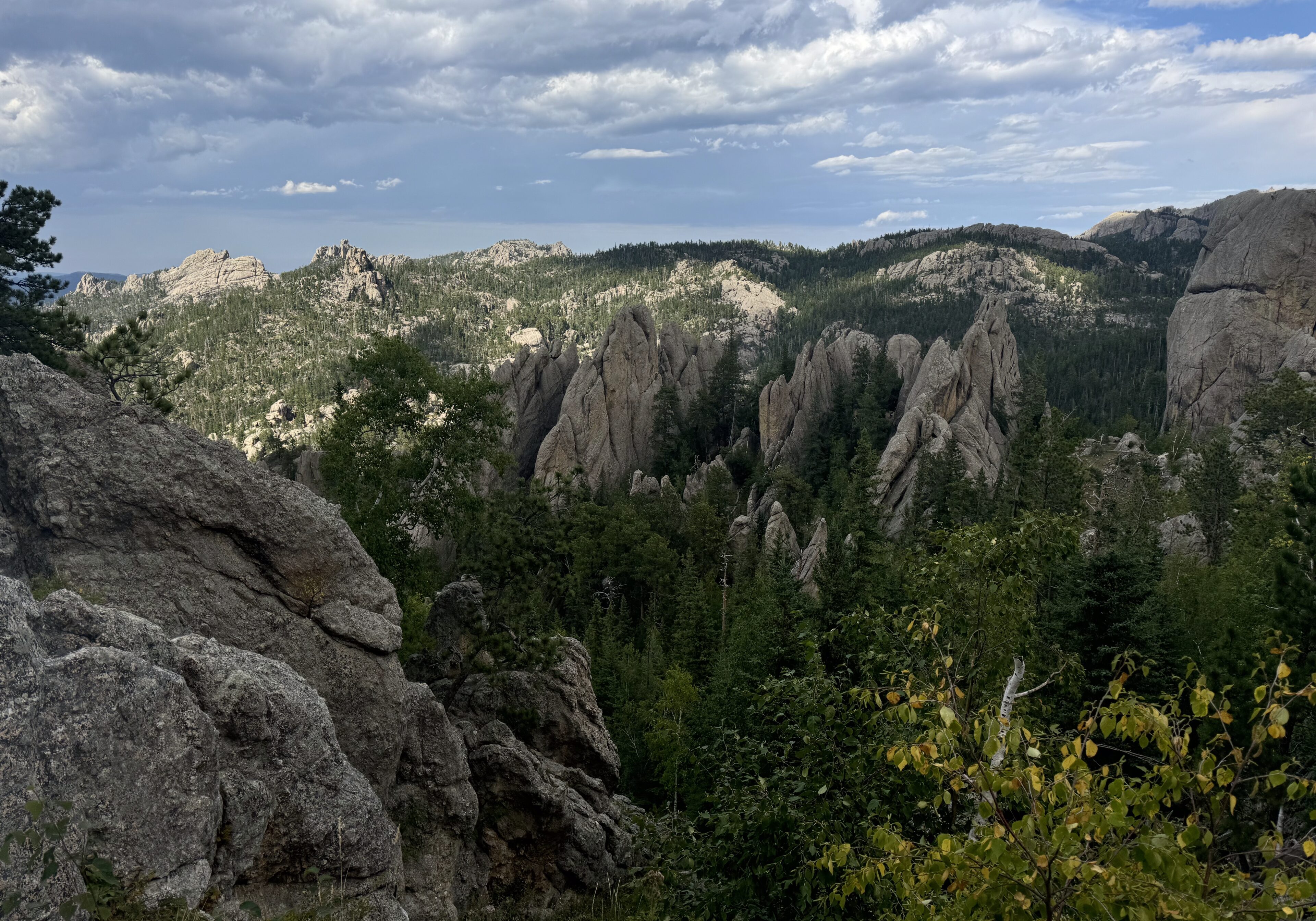 Scenic rocky mountain landscape under a partly cloudy sky.