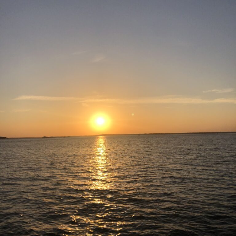 Golden sunset over calm sea with reflection