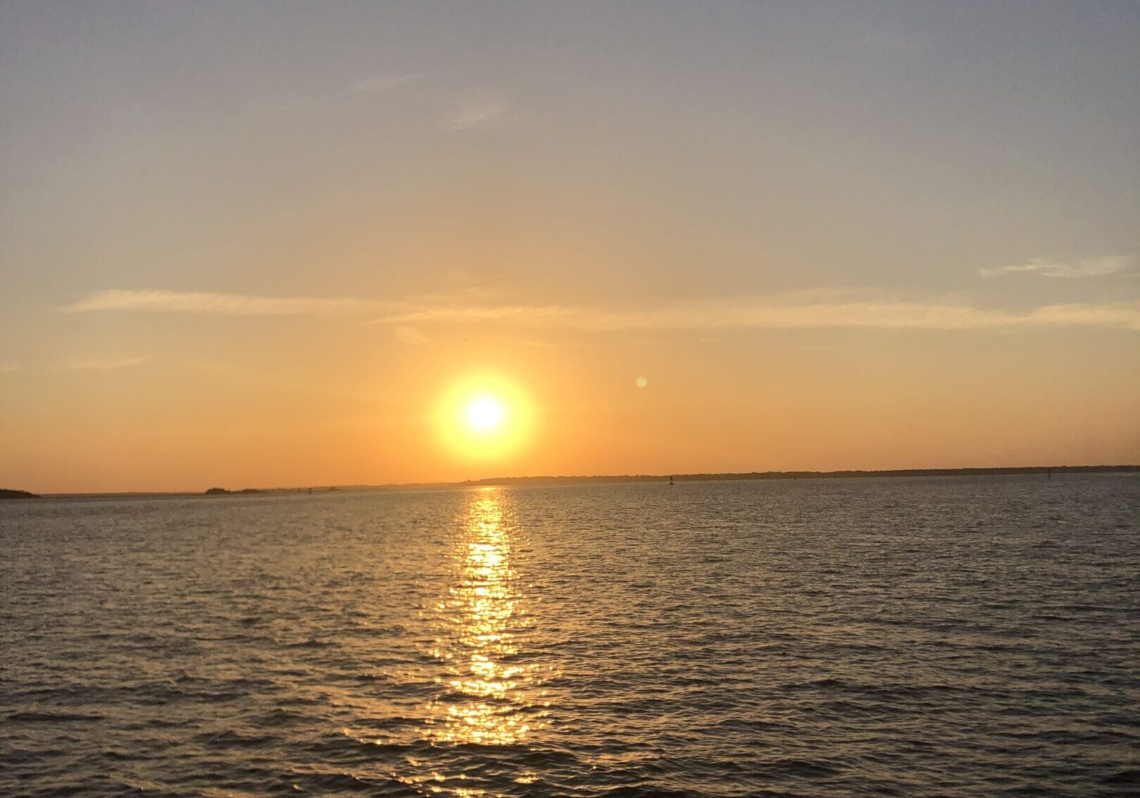 Golden sunset over calm sea with reflection